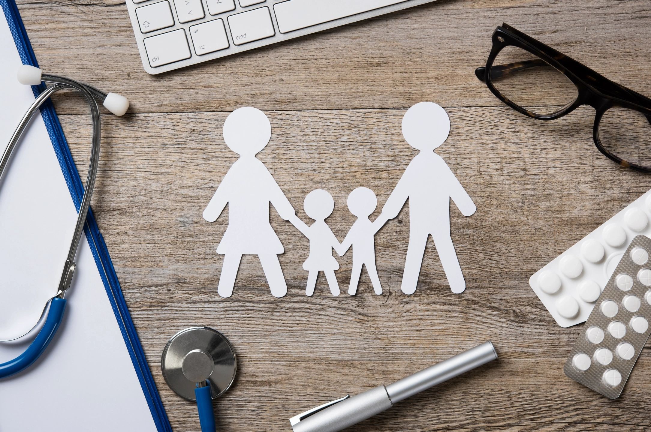 Picture of a cutout family n a desk with a stethescope